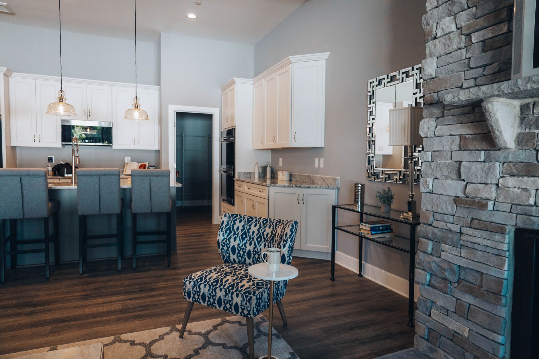 Contemporary kitchen interior featuring a stone fireplace, modern cabinetry, and chic furnishings in Austin, TX